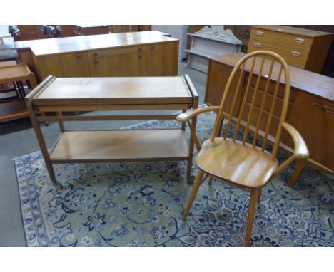 An Ercol style beech elbow chair and a teak metamorphic trolley 