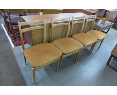 A set of four light elm dining chairs