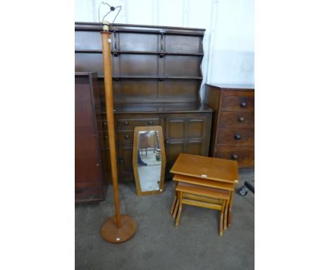 A teak standard lamp, nest of tables and a teak framed mirror 