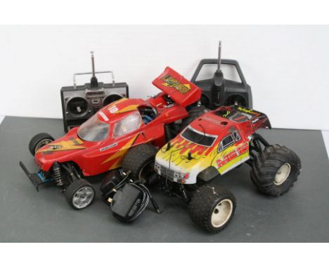 A Thunder Tiger 1/10 Nitro 4WD RC buggy, shaft driven together with a CEN 1/16 scale Nitro Monster Truck MG16 4WD shaft drive