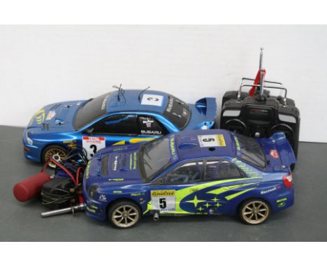 A Kyosho 4WD Subaru Nitro 1/10 scale Rally De France, belt driven RC car, McCrae / Grist together with a HPI Racing 4WD Subar