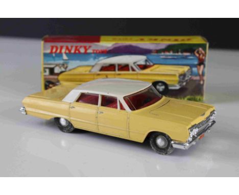 Boxed Dinky (Hong Kong) 57 / 003 Chevrolet Impala diecast model in pale yellow with white roof, red interior, diecast and box