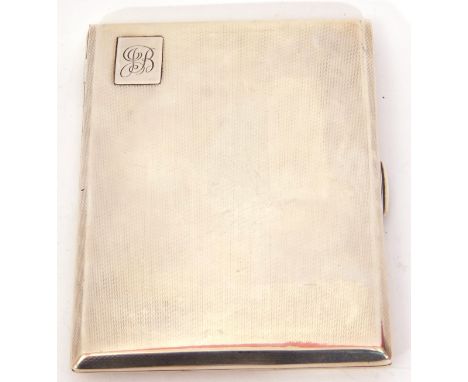 Art Deco cigarette case of rectangular form, having engine turned decoration front and back, the corner with a raised monogra