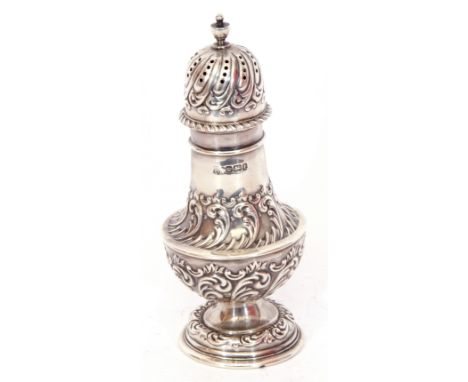 Edward VII silver caster of typical baluster form, embossed with scrolls, the pierced domed pull off lid with similar decorat