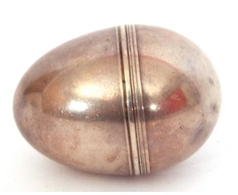 George III egg shaped nutmeg grater, the plain body with engraved monogram M W, having a threaded lid, opens to reveal a pull