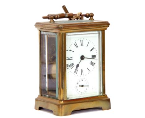 Last quarter of 19th/first quarter of 20th century brass and glass cased carriage clock of plain rectangular form with rounde