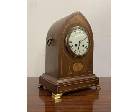 An Edwardian bracket clock, the mahogany case of lancet form inlaid with boxwood stringing and paterae, brass handles to each