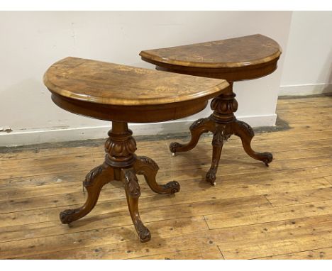 A Pair of Victorian figured walnut demi-lune card tables, the tops with boxwood string and scrolled floral inlay, with moulde