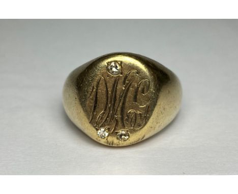 A gentleman's 9ct gold diamond-set signet ring, the oval plaque engraved with a monogram and gypsy-set with three diamond poi