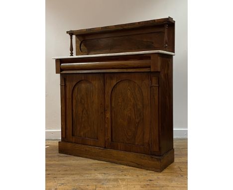 A rosewood chiffonier, first half of the 19th century, the open shelf with pierced brass gallery on spindle supports over sha