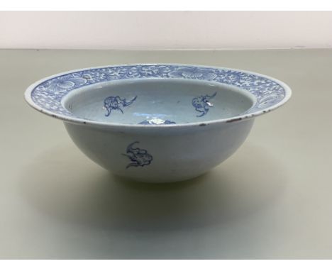 A Chinese blue and white porcelain basin, the well and broad rim painted with flowerheads amidst scrolling foliage, further p