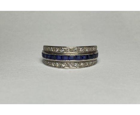A diamond, sapphire and ruby "Night and Day" full hoop eternity ring, the central band with line-edge set square-cut rubies a