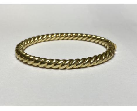 A yellow metal ropetwist hinged bangle, unmarked. Internal width 62mm, 23 grams