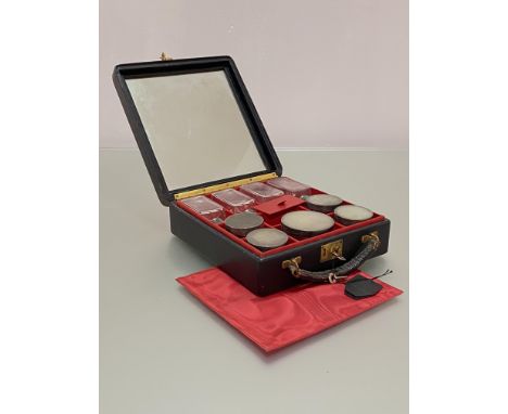 A George VI silver-mounted travelling toilet set, the black morocco case opening to a fitted interior containing five cut-gla