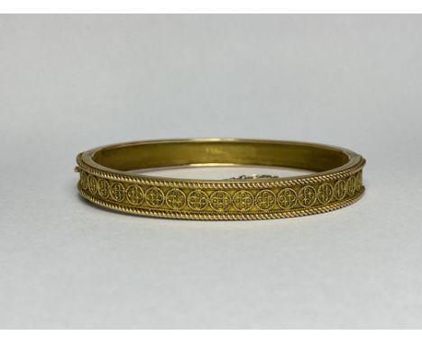A Victorian 9ct gold hinged bangle, one half applied with wirework decoration, bearing presentation inscription and hallmarke