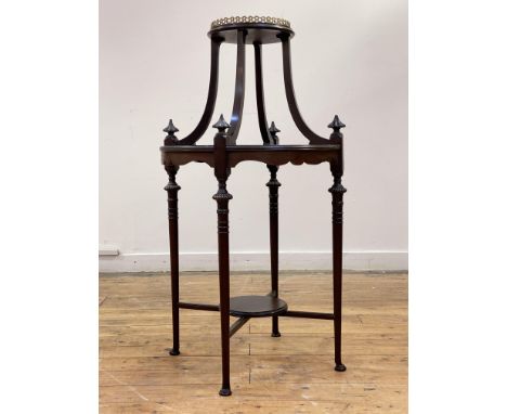 An Edwardian mahogany vase stand, the circular moulded top with gilt brass openwork gallery standing on four bowed stretchers