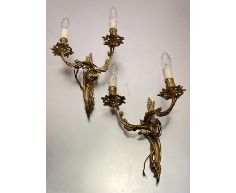 A pair of Louis XV style gilt-metal two light wall appliques cast with foliate scrolls; together with a gilt tole two light w