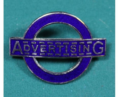 A London Transport ADVERTISING cap badge. Dark blue enamel on chrome badge. 'J.R. Gaunt London' stamped to reverse. GC-VGC, s