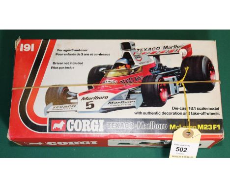 A 1:18 scale Corgi Toys Texaco-Marlboro McLaren M23 F1. In Texaco-Marlboro red &amp; white livey. 'With authentic decoration 