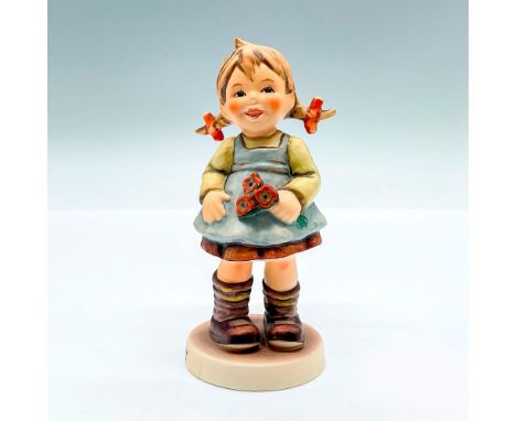 Hand painted figure for the M.I. Hummel exclusive collection. A young girl holding flowers. Goebel backstamp. This item has i