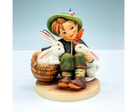 Matte finished figurine depicting a young boy with three rabbit pets. Goebel backstamp. M.I. Hummel impressed mark 58. This i