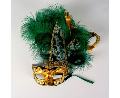 Eye catching wearable hand crafted paper mache mask in green and gold with glitter, tapestry panels and feather design. Braid