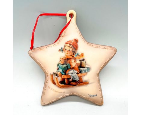A star-shaped hanging decor featuring the image of a Hummel figurine, Christmas Delivery HUM 2014. Goebel marked. Artist: MI.