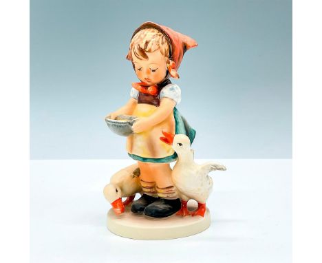 Matte finished figurine of a girl feeding ducks colored in orange, brown, and blue. Goebel backstamp. M.I. Hummel impressed m