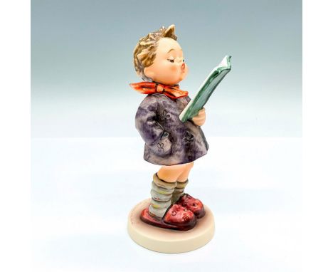 Hand painted figure of a young boy reading from a book. Goebel backstamp. This item has its original box: 5"L x 3.75"W x 7.5"