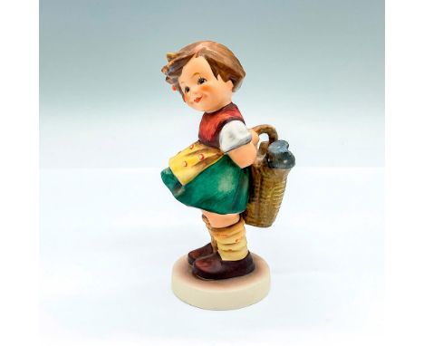 A hand painted figure of a young girl shyly smiling and holding a basket of flowers. Goebel backstamp. Artist: M.I. HummelIss
