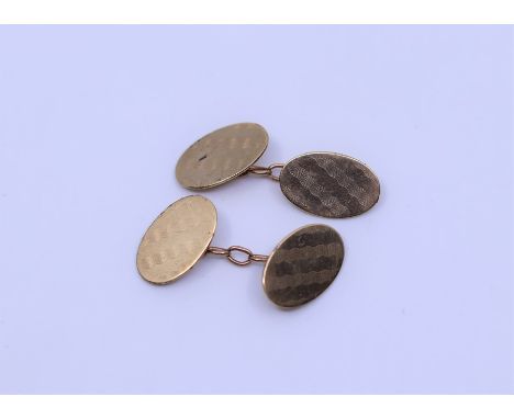 Pair of oval 9ct cuff links, engine turned, approx 6.7g