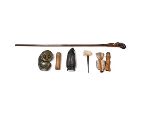 A carved root handled walking stick, a carved Indonesian horn container, an African Honer sculpture, a carved clay pipe etc (