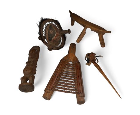 A Papua New Guinea ceremonial bone dagger, a painted straw mask, a tribal instrument and a carved stool. Condition - fair/goo
