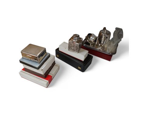A George V silver cigarette box and assorted plated ware to include a cased cruet, a modern silver wine coaster and an emboss