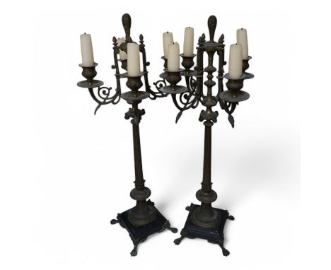 A pair of four branch candelabra raised on slate bases with paw feet, 62cm high. Condition - fair/good