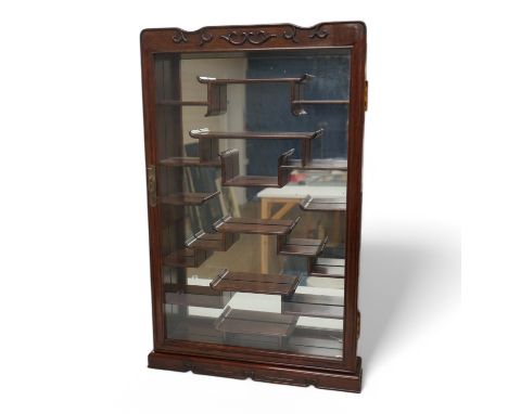 A narrow Chinese hardwood display cabinet, fitted with decorative shaped hardwood shelving, 82.5cm high x 53cm wide at base  