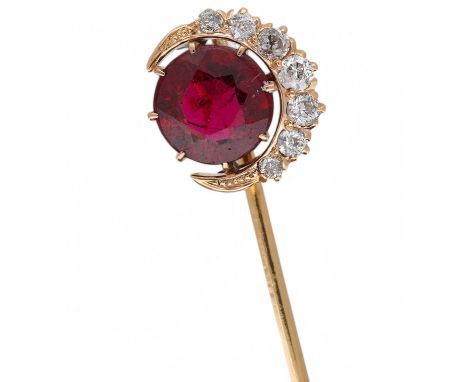 An early to mid 20th century yellow metal and single stone garnet topped doublet set stick pin, with diamond set crescent bor