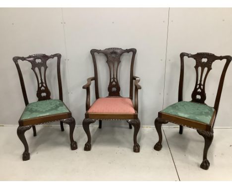 A set of three Chippendale style mahogany dining chairs, one with arms. Condition - fair