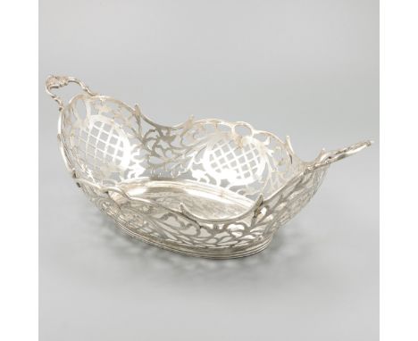 Bread basket silver. Beautiful model with soldered rocaille handles and partly openwork sides with engraved details. Bottom e