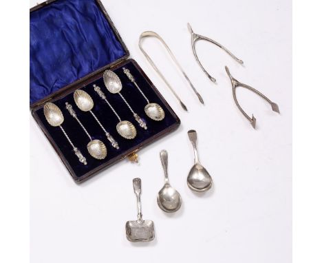 A PAIR OF GEORGIAN SILVER BRIGHT CUT SUGAR TONGS, by Hester Bateman; three various caddy spoons; a set of six silver apostle 