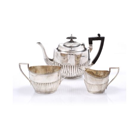 A FLUTED SILVER THREE PIECE TEA SERVICE, teapot, sugar basin and milk jug, engraved initials, Sheffield 1918/19 by Walker & H