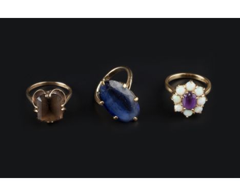 THREE GEM SET RINGS, comprising an amethyst and opal oval cluster ring, 18ct gold mounted, a smoky quartz single stone ring, 