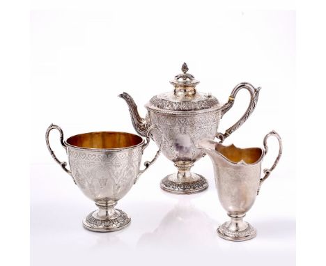 A VICTORIAN SILVER THREE PIECE TEA SERVICE, of urn shaped design, engraved with stylised foliage and strapwork and with beade