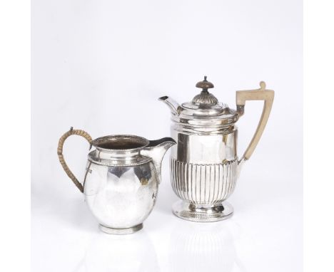 A LATE VICTORIAN SILVER WATER JUG with a fluted lower body, matching domed lid and wooden handle, 18.5cm high, London 1889 by