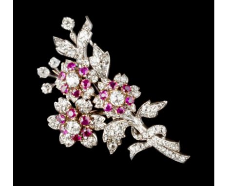A RUBY AND DIAMOND FLORAL SPRAY BROOCH, centred with three flowerheads of circular and oval mixed-cut rubies and old-cut diam