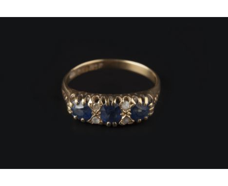 A SAPPHIRE AND DIAMOND HALF HOOP RING, the oval mixed-cut sapphires spaced by lasque-cut diamond points, 18ct gold mounted, r