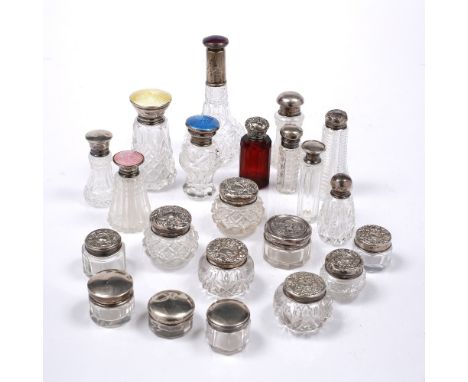 A COLLECTION OF TWENTY TWO GLASS, SILVER AND ENAMEL MOUNTED SCENT BOTTLES AND JARS, varying age and maker, 11.8 - 2cm high (2