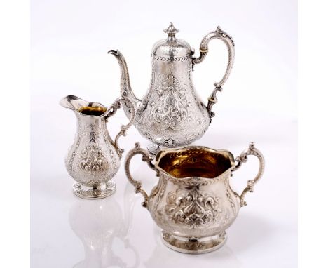 A VICTORIAN SILVER THREE PIECE TEA SERVICE of baluster form, repoussé decorated with cartouches and stylised foliage, compris