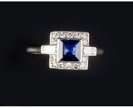 AN ART DECO SAPPHIRE AND DIAMOND PANEL RING, the square step-cut sapphire collet set within a border of single-cut diamonds, 