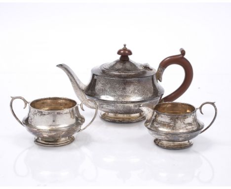 A GEORGE V SILVER THREE PIECE TEA SET by Joseph Gloster Ltd, 1931, comprising a circular teapot with matching milk jug and a 